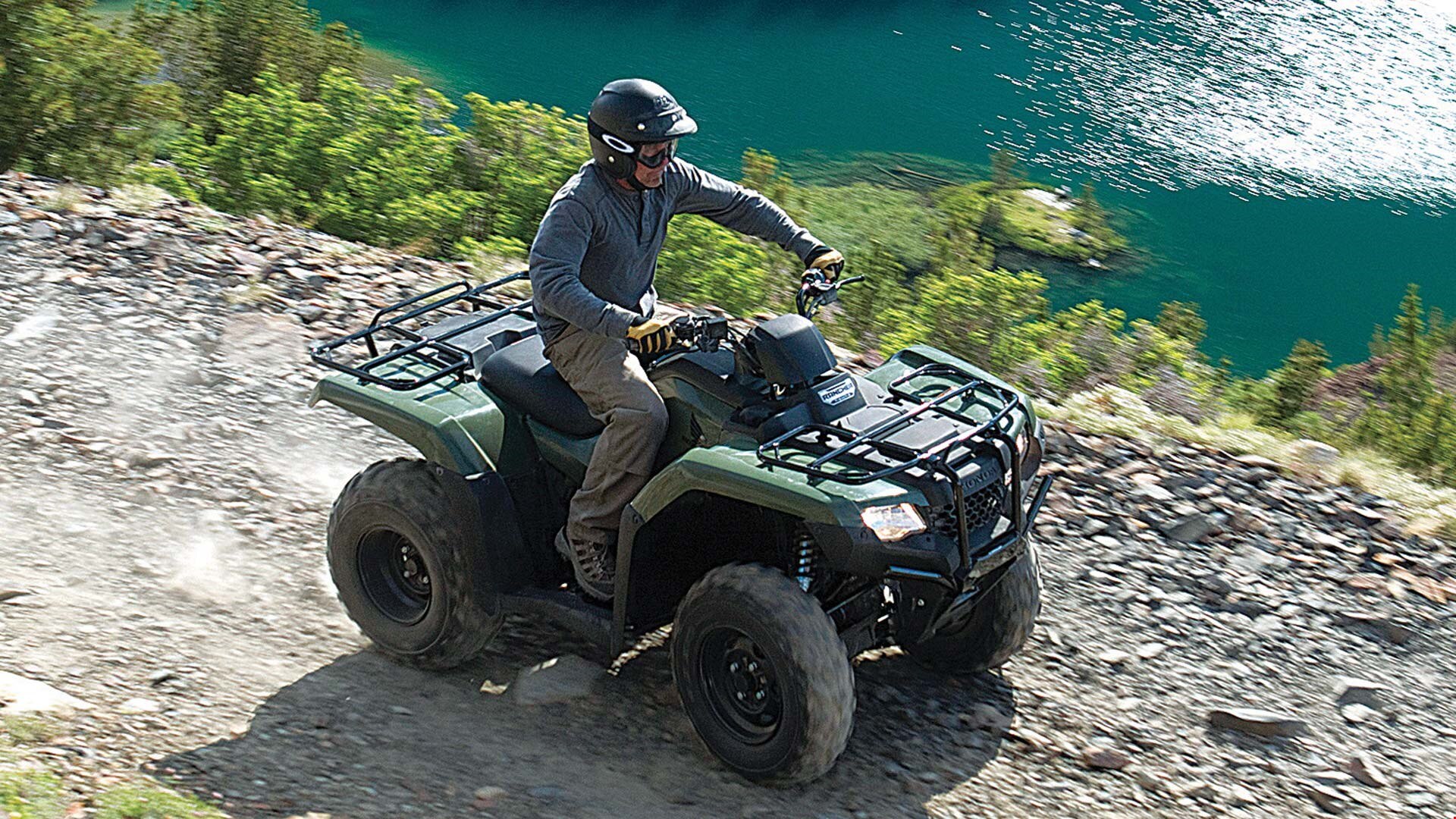 2018 honda rancher 420. contemporary rancher rider driving trx420 rancher in colour olive on rugged trail along turquoise lake and 2018 honda rancher 420